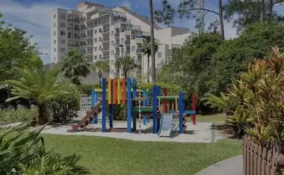 a playground in a park in front of a building at Remodeled 2BD/2BA Condo mins from Universal Studio in Orlando