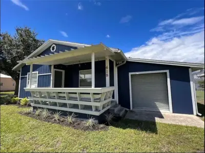 a blue house with a garage at 3-Bed Bungalow walk to Historic Downtown Sanford in Sanford