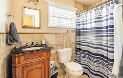 a bathroom with a toilet and a sink and a shower at 3-Bed Bungalow walk to Historic Downtown Sanford in Sanford