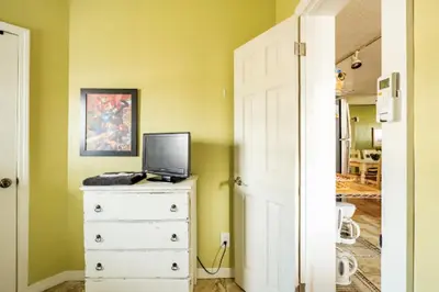 a bedroom with a dresser with a laptop on top of it at 3-Bed Bungalow walk to Historic Downtown Sanford in Sanford