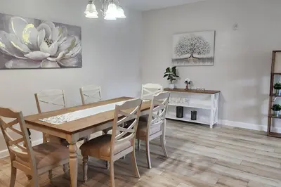 a dining room with a wooden table and chairs at Apartment Kissimmee - Orlando in Kissimmee