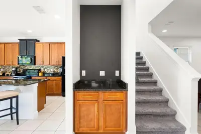 a kitchen and a staircase in a house at Delightful Home Near Disney With Private Pool And Waterpark & Resort Access At Encore Resorts Reunion - 441No in Kissimmee