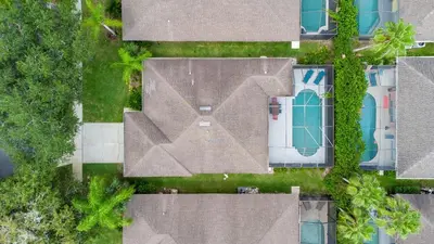 an overhead view of a roof of a house and a pool at Yelleville on Sunset! 4 Miles to Disney in Kissimmee