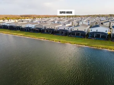 an aerial view of a large apartment complex next to the water at 7 BR Large Pool Game Room @ Storey Lake SL2861 in Kissimmee