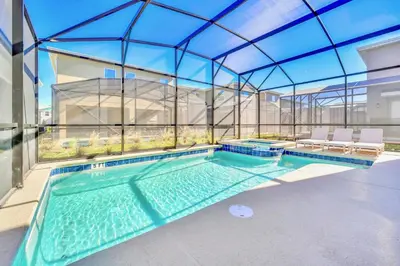 a swimming pool in a house with a glass ceiling at Upstay 6BR Resort Home w Pool & Basketball Court in Kissimmee
