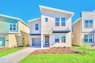 a large house with a driveway at Upstay 6BR Resort Home w Pool & Basketball Court in Kissimmee