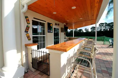 a patio with a bar with stools on it at Emerald Island Escape- Pool and spa in Kissimmee