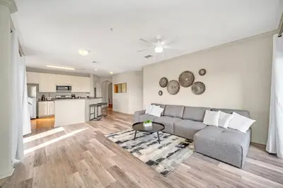 a living room with a couch and a table at Condo w Pool, Games Room - Pet Friendly in Orlando