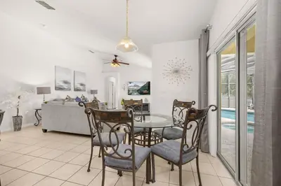 a dining room and living room with a table and chairs at #196-Fantastic 6 bed villa with own private pool and spa with no rear neighbors in Orlando
