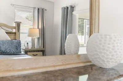 a bedroom with a bed and a mirror at #196-Fantastic 6 bed villa with own private pool and spa with no rear neighbors in Orlando