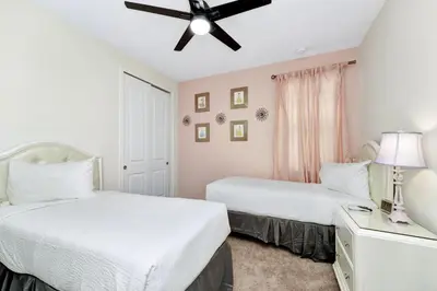a bedroom with two beds and a ceiling fan at Vibrant Home Near Disney With Private Pool, Game Room And Waterpark & Resort Access At Encore Resorts Reunion - 7572Mr in Kissimmee