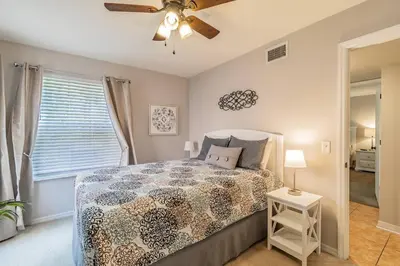 a bedroom with a bed and a ceiling fan at LOVE AT FIRST SIGHT! NEW Disney Home, Sleeps 6, Pool, Patio, NO Steps, LOW Rates! in Kissimmee
