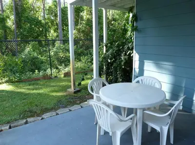 a white table and white chairs on a patio at LOVE AT FIRST SIGHT! NEW Disney Home, Sleeps 6, Pool, Patio, NO Steps, LOW Rates! in Kissimmee