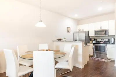 a kitchen and dining room with a table and chairs at Lovely and Cozy Townhome Near Disney Parks in Kissimmee