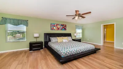 a bedroom with a bed and a ceiling fan at Shvcc2 - Crystal Cove #2 - 7 Bed 45 Baths Villa in Kissimmee