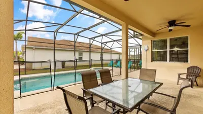 a patio with a glass table and chairs and a pool at Shvcc2 - Crystal Cove #2 - 7 Bed 45 Baths Villa in Kissimmee