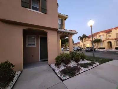 a apartment building with a sidewalk and a street at Shvpc3 - Paradise Cay #3 - 3 Bed 25 Baths Townhome in Kissimmee