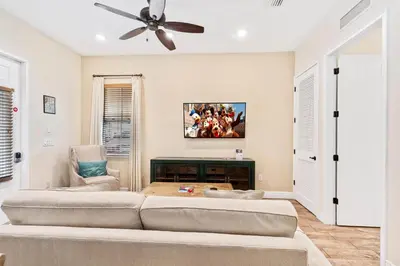 a living room with two beds and a ceiling fan at 3000 Latitude Lane in Orlando