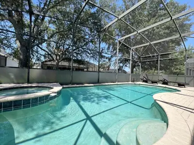an indoor swimming pool with a large glass roof at Callaghan Cantina home in Orlando
