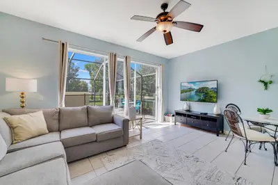 a living room with a couch and a ceiling fan at Windsor Hills Townhome in Orlando