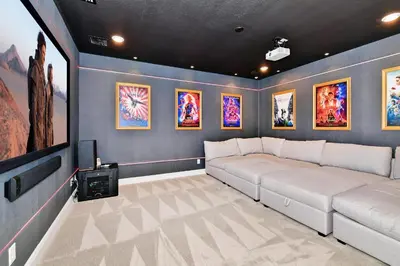 a living room with a couch and a tv at Elite Home Near Disney With Theater Room, Game Room And Private Pool With Water Park Access At Encore Resorts Reunion - 200Au in Kissimmee