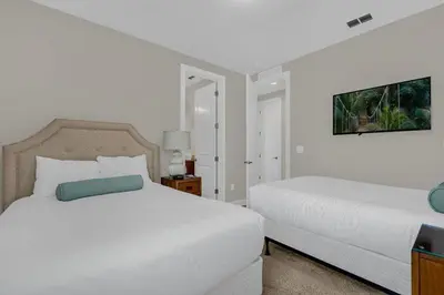 a white bedroom with two beds at 541 Villa- 7BD Dream Home - Private PoolSpa in Orlando
