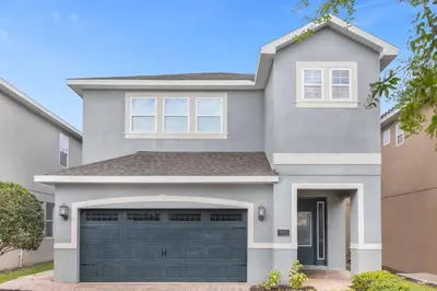 a gray house with a garage at 541 Villa- 7BD Dream Home - Private PoolSpa in Orlando