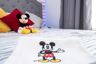 two mickey mouse towels are sitting on a bed at Your Orlando home 15 min to Disney - KGG01 in Kissimmee