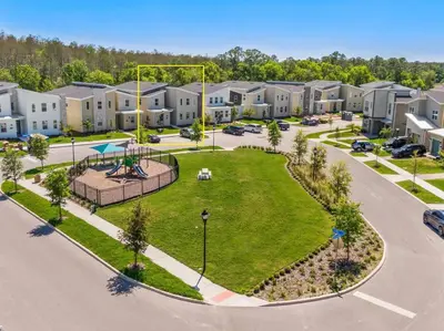 an aerial view of an apartment complex with a park at Luxury 9BR Villa @ Storey Lake Resort Near Disney in Kissimmee