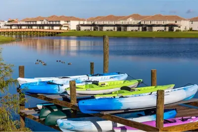 a group of boats tied to a dock in the water at Amazing 6BR Villa @ Storey Lake Resort Near Disney in Kissimmee
