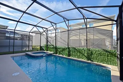 a swimming pool in front of a glass house at Amazing 6BR Villa @ Storey Lake Resort Near Disney in Kissimmee