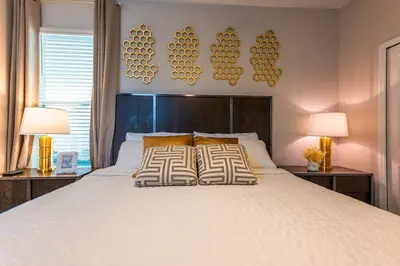 a bedroom with a large white bed with two lamps at Modern Adventure Home near to Disney in Kissimmee
