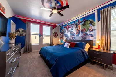 a bedroom with a captain america painting on the wall at Magical Themed Home - Disney 15 min in Kissimmee