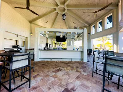 a room with chairs and a bar with a television at Magical Themed Home - Disney 15 min in Kissimmee