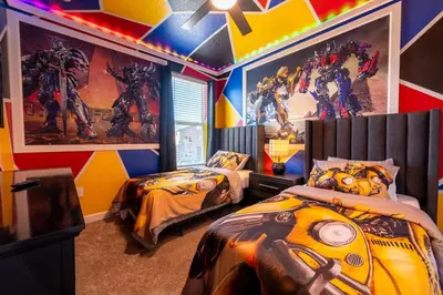 a superhero themed bedroom with two beds and a marvel mural at Magical Themed Home - Disney 15 min in Kissimmee