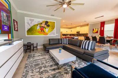 a living room with a couch and a table at 6BR Disney Oasis with Pool, Game Room and Resort in Kissimmee