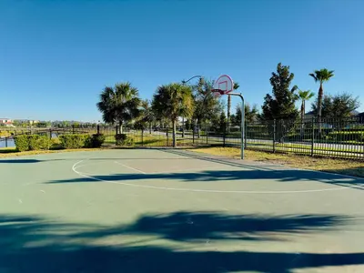 a tennis court with a basketball hoop at 6BR Disney Oasis with Pool, Game Room and Resort in Kissimmee