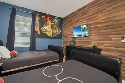 a bedroom with a bed and a tv on a wall at Serene Sunsets Villa - E04 in Kissimmee