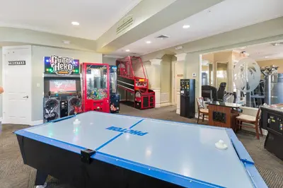 a pool table in a room with arcade games at One in a Minion #102 in Orlando