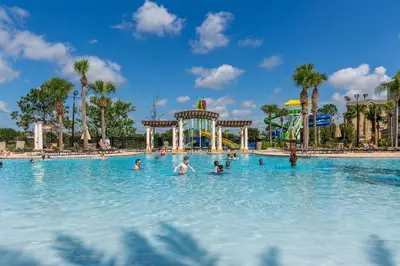 a group of people in a swimming pool at a theme park at Mickey Mouse #104 in Orlando