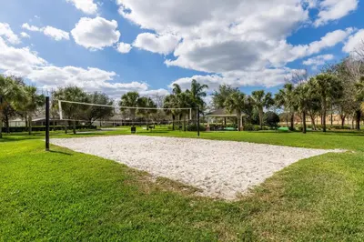 a volleyball court in a park with palm trees at Windsor Hills Resort #102 in Orlando