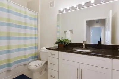 a bathroom with a sink and a toilet and a mirror at Windsor Hills Resort #202 in Orlando