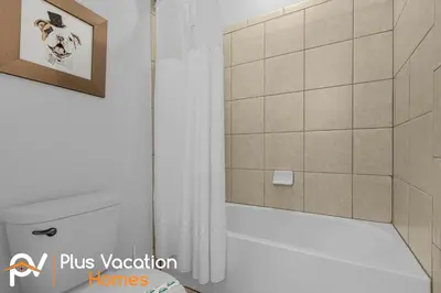 a bathroom with a shower with a toilet and a sink at 7594 Oasis 8BD Villa- poolspa in Orlando
