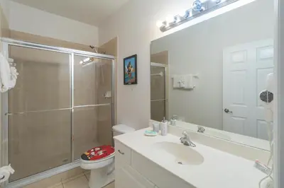 a bathroom with a shower and a sink and a toilet at Huge Screened Patio That Overlooks Lake Buck, Near Famous Attractions!! in Orlando