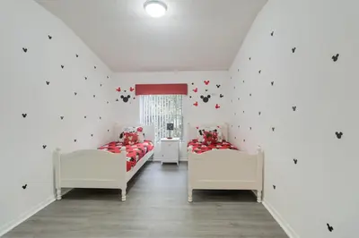 two beds in a room with white walls at Huge Screened Patio That Overlooks Lake Buck, Near Famous Attractions!! in Orlando