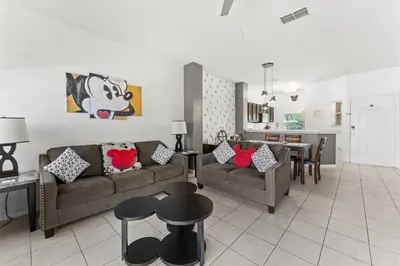 a living room with a couch and a dining room at *PRIVATE POOL* Disney10min - Magical Mickey themed home in Kissimmee