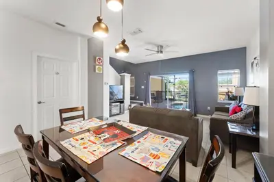 a dining room and living room with a table and chairs at *PRIVATE POOL* Disney10min - Magical Mickey themed home in Kissimmee