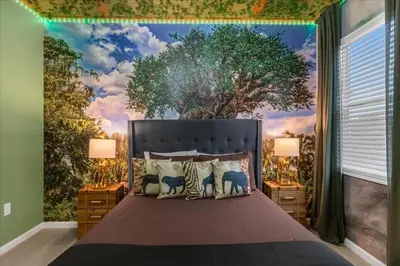 a bedroom with a tree mural on the wall at 5BR Family Home with Pool & Hot Tub Near Disney in Kissimmee