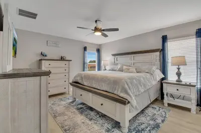 a bedroom with a bed and a ceiling fan at 6 Bedroom Luxury Pool Home, Ensuite Bathrooms in Kissimmee