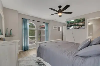 a bedroom with a bed and a ceiling fan at 6 Bedroom Luxury Pool Home, Ensuite Bathrooms in Kissimmee